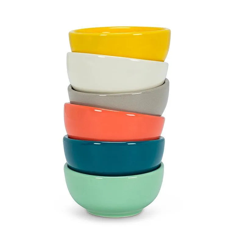 Stack of colorful ceramic bowls on a white background
