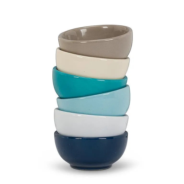 Stack of colorful ceramic bowls on a white background