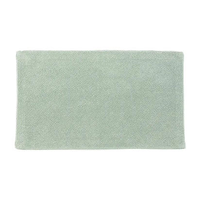Green bath mat on a white background