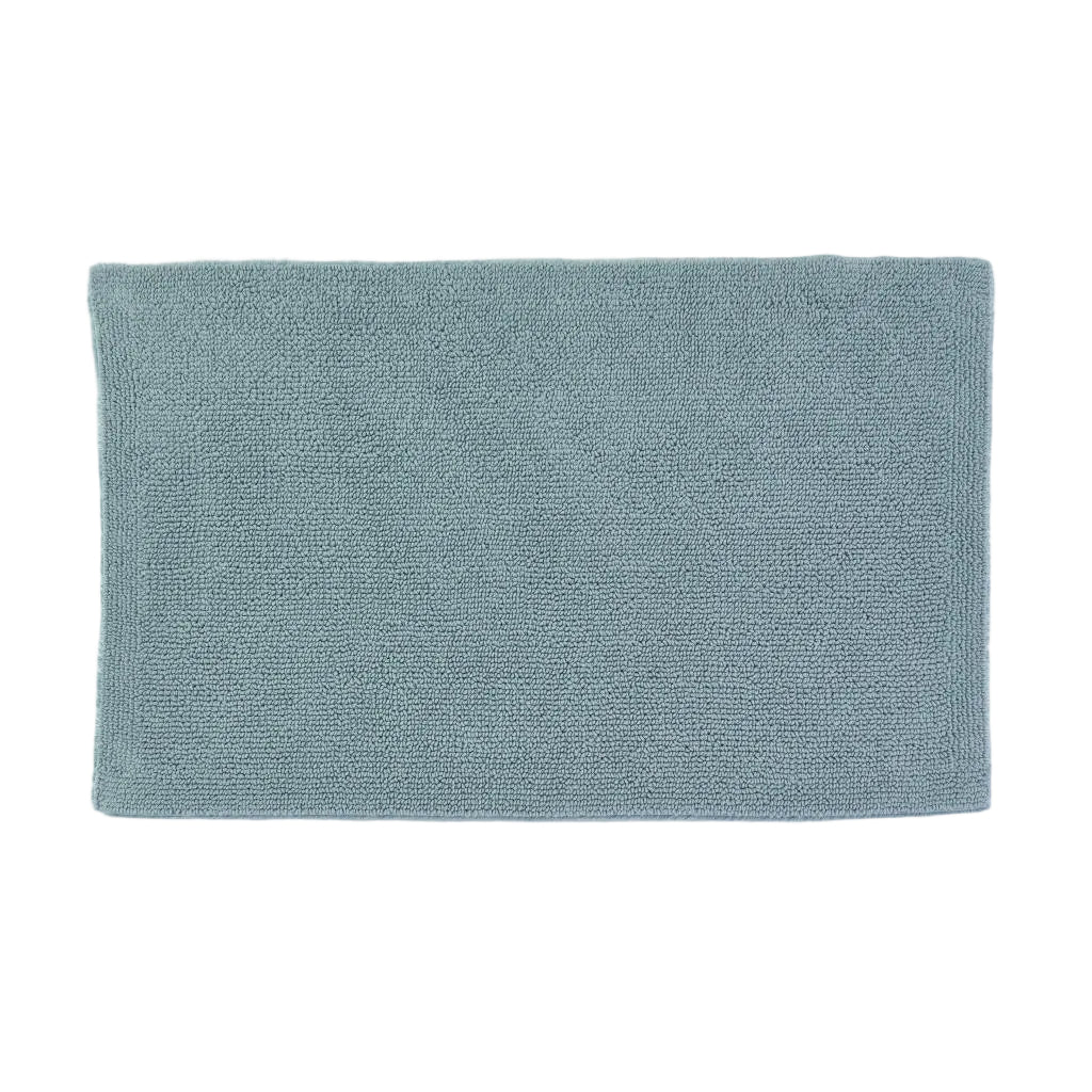 Rectangular teal bath mat on a white background