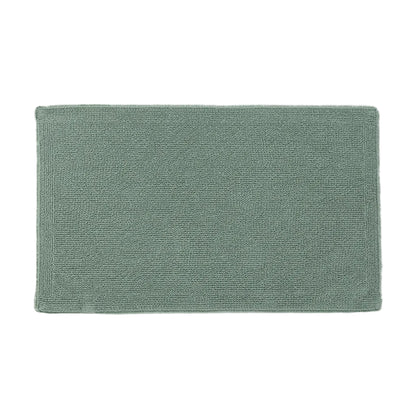 Green bath mat on a white background
