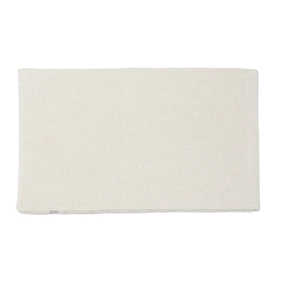 Beige bath mat on a white background