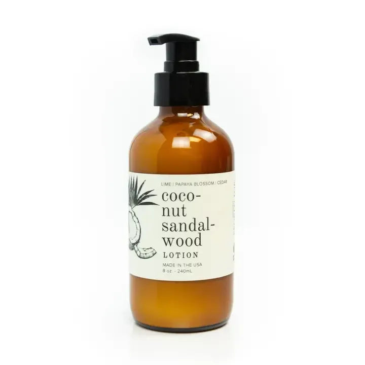 Amber lotion bottle with pump and coconut sandalwood label on a white background