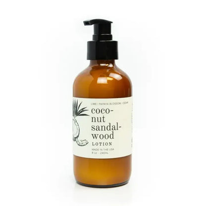 Amber lotion bottle with pump and coconut sandalwood label on a white background