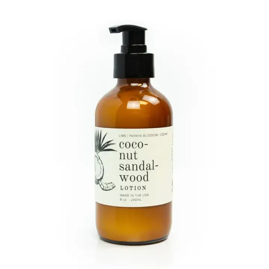 Amber lotion bottle with pump and coconut sandalwood label on a white background