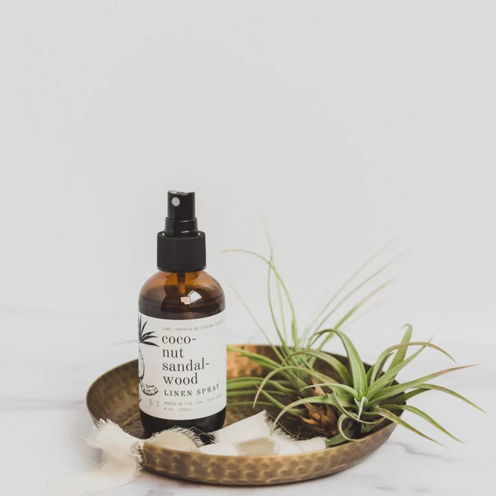 Linen and Room Spray on metal tray next to succulent plants, labelled coconut sandalwood