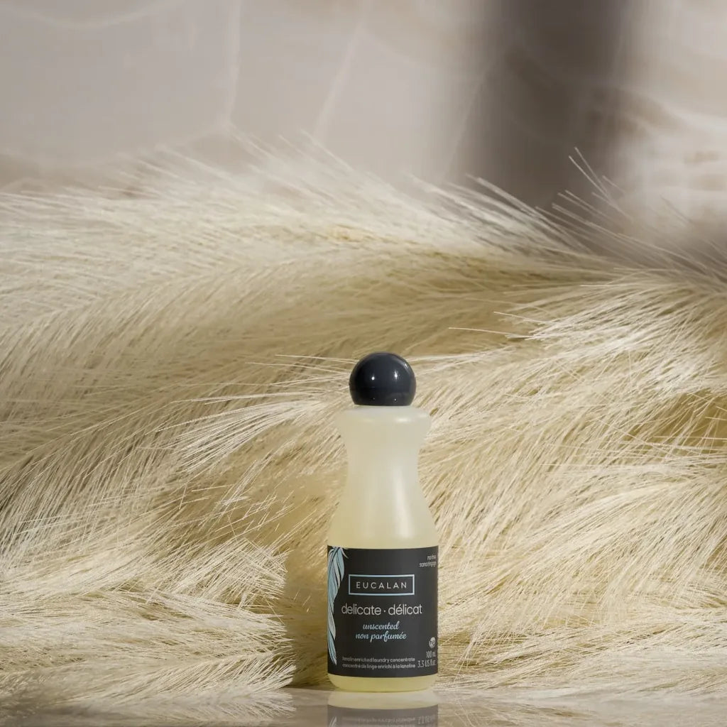Bottle of Eucalan soap on a textured beige surface