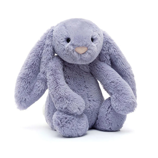 Plush toy rabbit in a sitting position on a white background