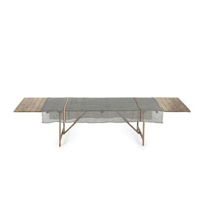 Long rectangular table with wooden ends and a linen grey cloth