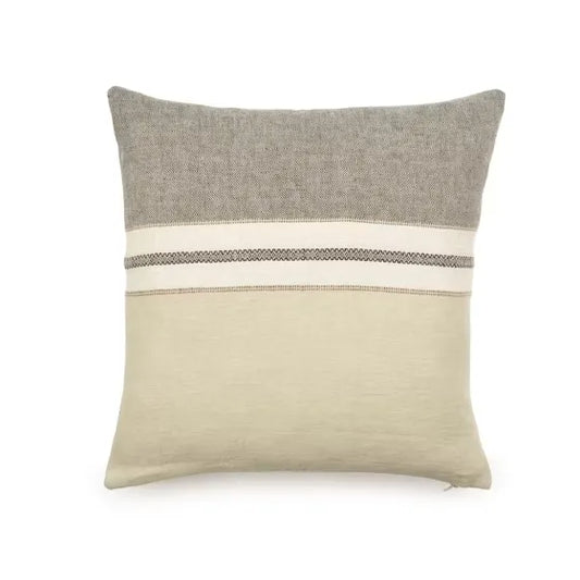 A square throw pillow in a textured linen-like fabric, featuring a two-tone design with a gray top half and a warm beige bottom half, divided by a horizontal stripe pattern band.