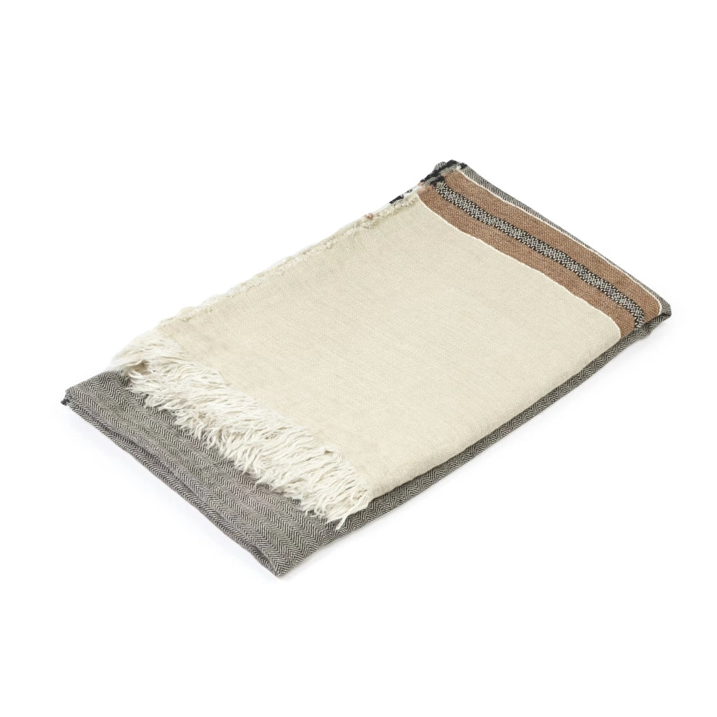Woven blanket with grey center, beige sides, and white fringe on a white background