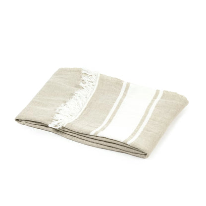 Folded beige blanket on a white background