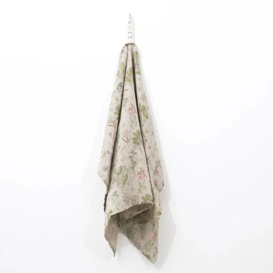 Floral-patterned towel hanging on a white wall
