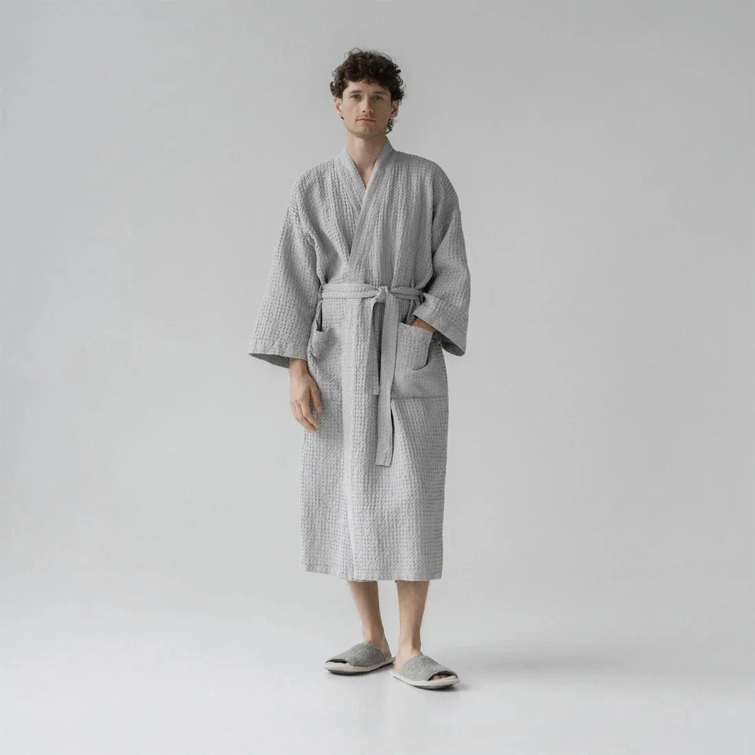 Man wearing a light gray honeycomb waffle weave robe by Linen Tales