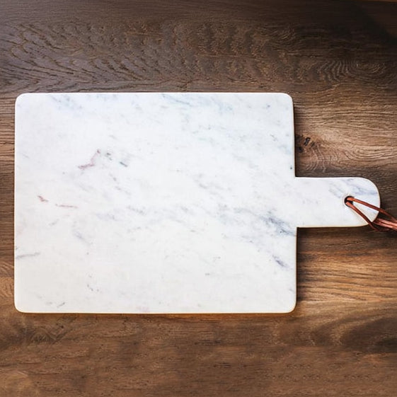 Marble paddle cutting board on wooden table