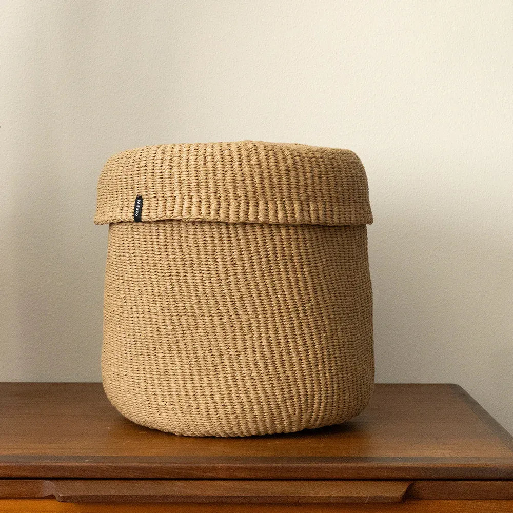Woven basket on a wooden surface with a plain background