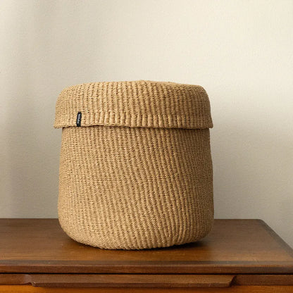 Woven basket on a wooden surface with a plain background