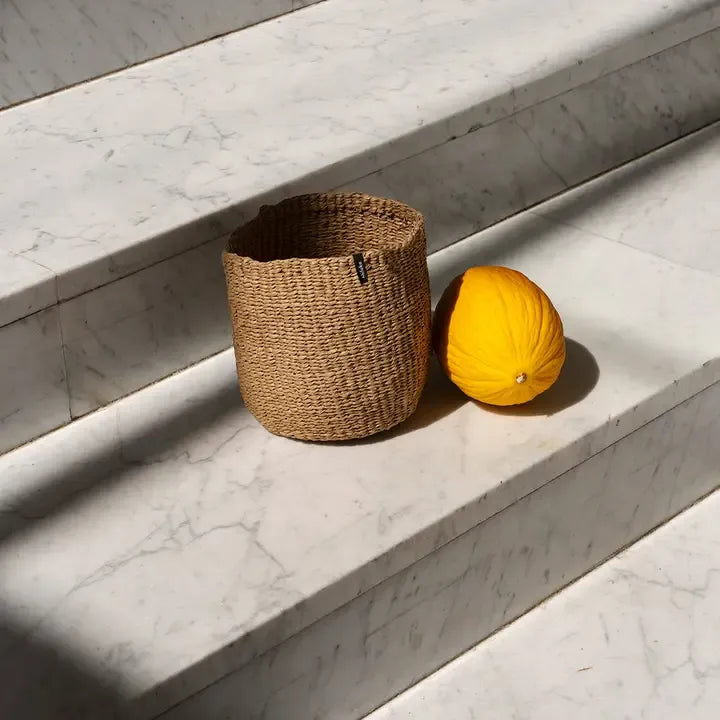 Mifuko Kiondo Basket in Brown on marble stairs