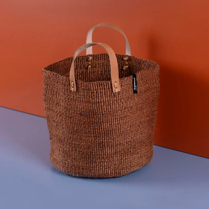 Woven basket with leather handles on a gradient background