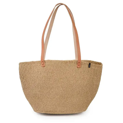 Woven handbag with tan leather handles on a white background