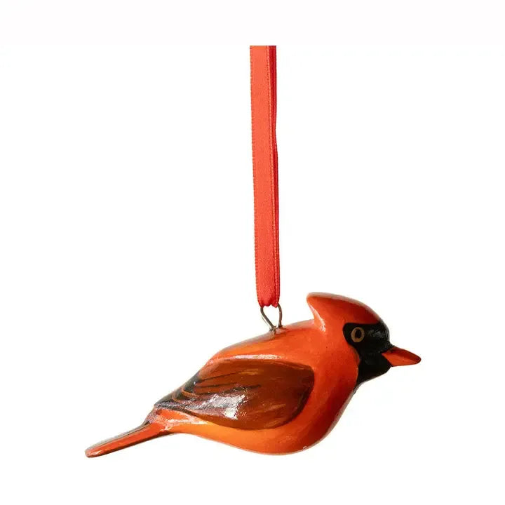 Decorative red bird ornament with a red ribbon on a white background