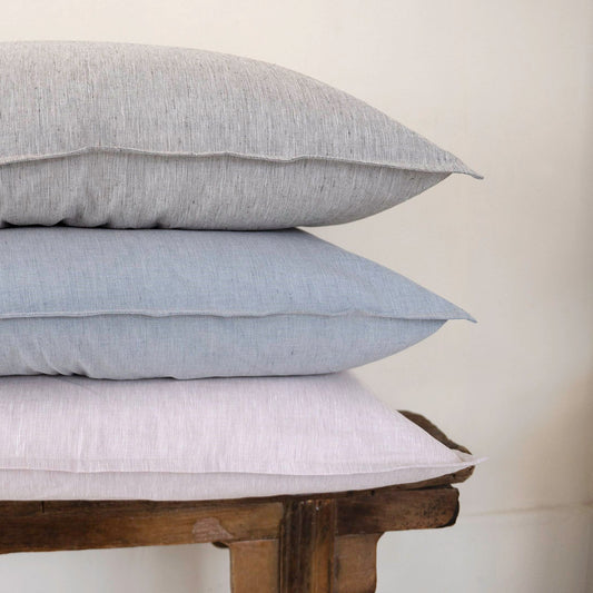 Three St Geneve Riva cushions stacked on a table