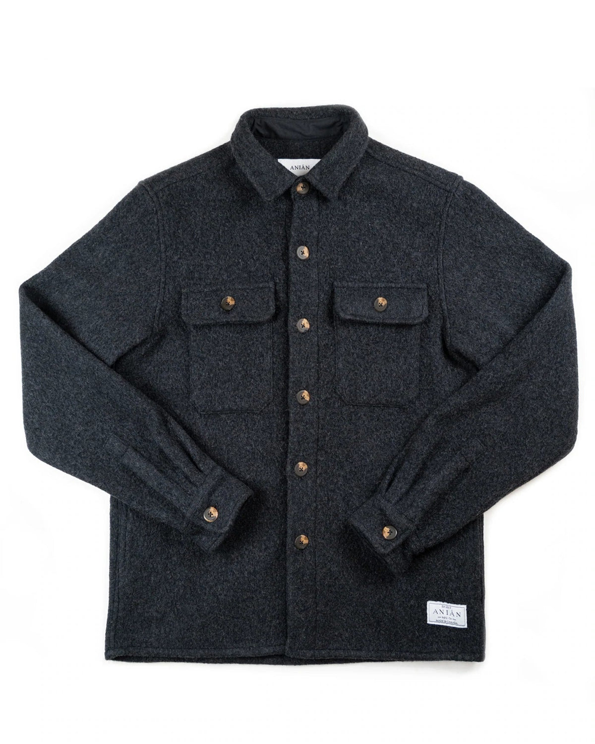 A dark charcoal gray wool button-up shirt jacket with brown buttons, laid flat on a white background. It features a classic collar, two buttoned chest pockets, and a small white woven label near the bottom right hem.
