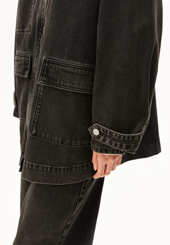 Side detail of ARMEDANGELS Canada Denim Jacket Cord Collar, showing the patch pocket and buttoned sleeve cuff.