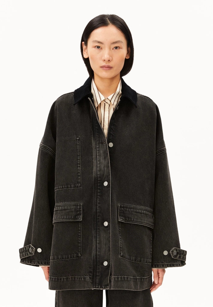 oman wearing ARMEDANGELS Canada Denim Jacket Cord Collar in a washed black denim with a black corduroy collar, front view against a white background.
