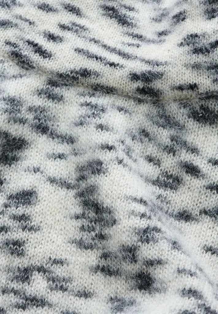 Close-up of the fluffy, speckled oatmilk and black flamé knit of ARMEDANGELS Canada Dotted Mohair-Blend Knit Vest.
