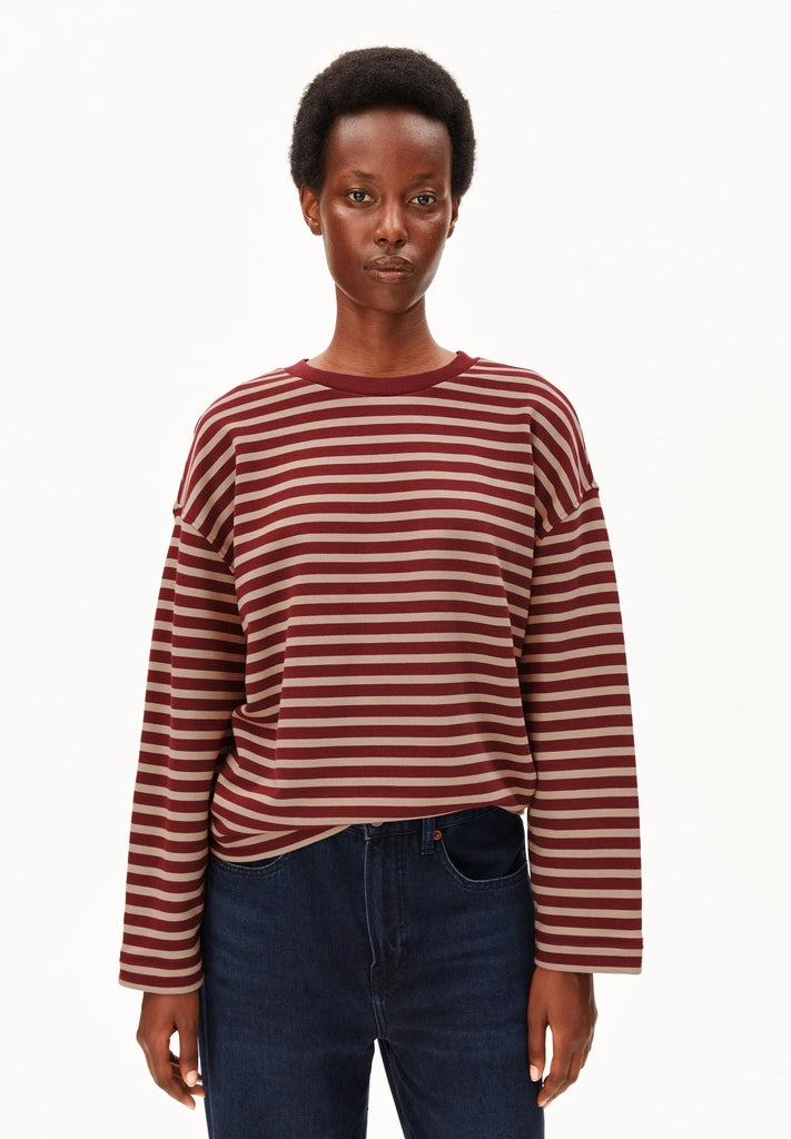 Woman wearing ARMEDANGELS Canada Frankaa Maarlen Stripe Sweatshirt in Velvet Red-Honey Reed with dark jeans, front view against a white background.