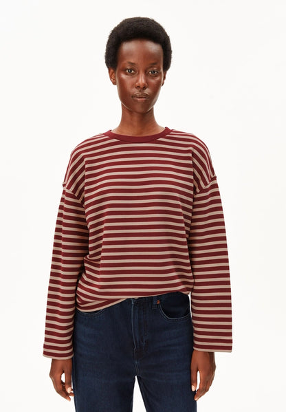 Woman wearing ARMEDANGELS Canada Frankaa Maarlen Stripe Sweatshirt in Velvet Red-Honey Reed with dark jeans, front view against a white background.