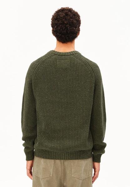 Back view of a man wearing the ARMEDANGELS Canada Kiaano Tweed Knit Sweater in Dark Earth Tweed on a white studio background.