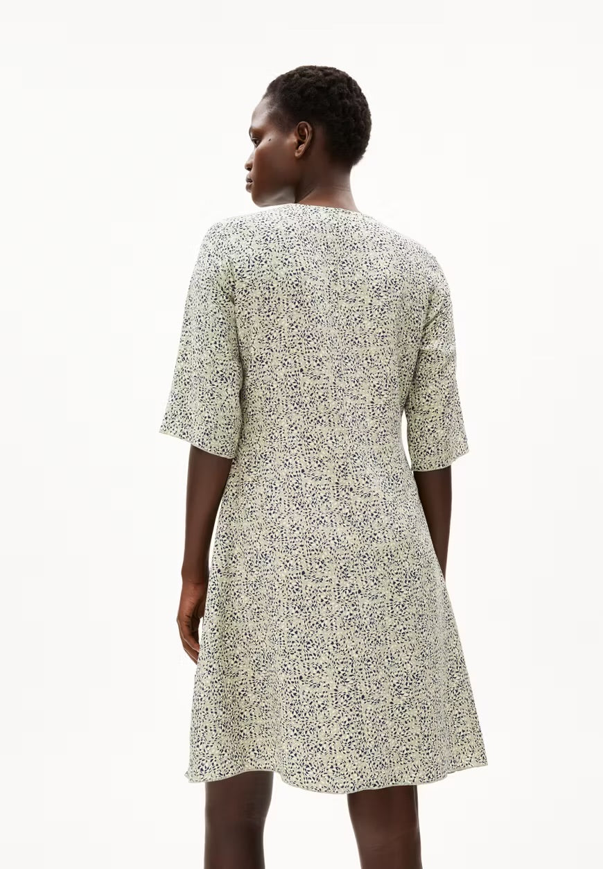 Back view of a woman wearing the ARMEDANGELS Canada Lilaat Waterdrop Dress in seagreen, showing the short sleeves and straight knee-length cut, against a white background