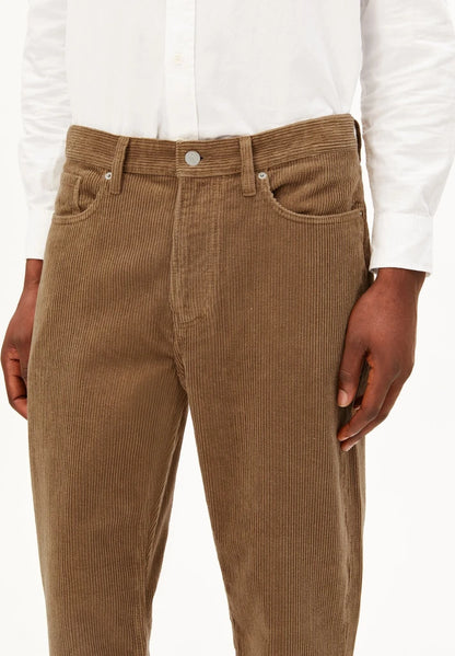 Close-up of ARMEDANGELS Canada Maakx Cord Trousers in Amberwood, showing the corduroy texture, front pockets and button fly, against a white background.