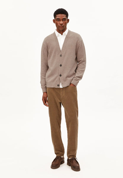 Man wearing ARMEDANGELS Canada Maakx Cord Trousers in Amberwood with a grey cardigan and white shirt, full-length front view against a white background.