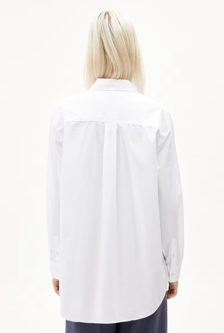 Back view of a woman wearing the ARMEDANGELS Canada Maalgaa Blouse in white, showing the back yoke and centre pleat, on a white background.