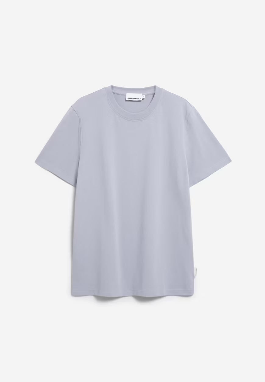 Front flatlay of the ARMEDANGELS Canada Maarkos Heavy Weight T-Shirt in misty morning on a light grey background.