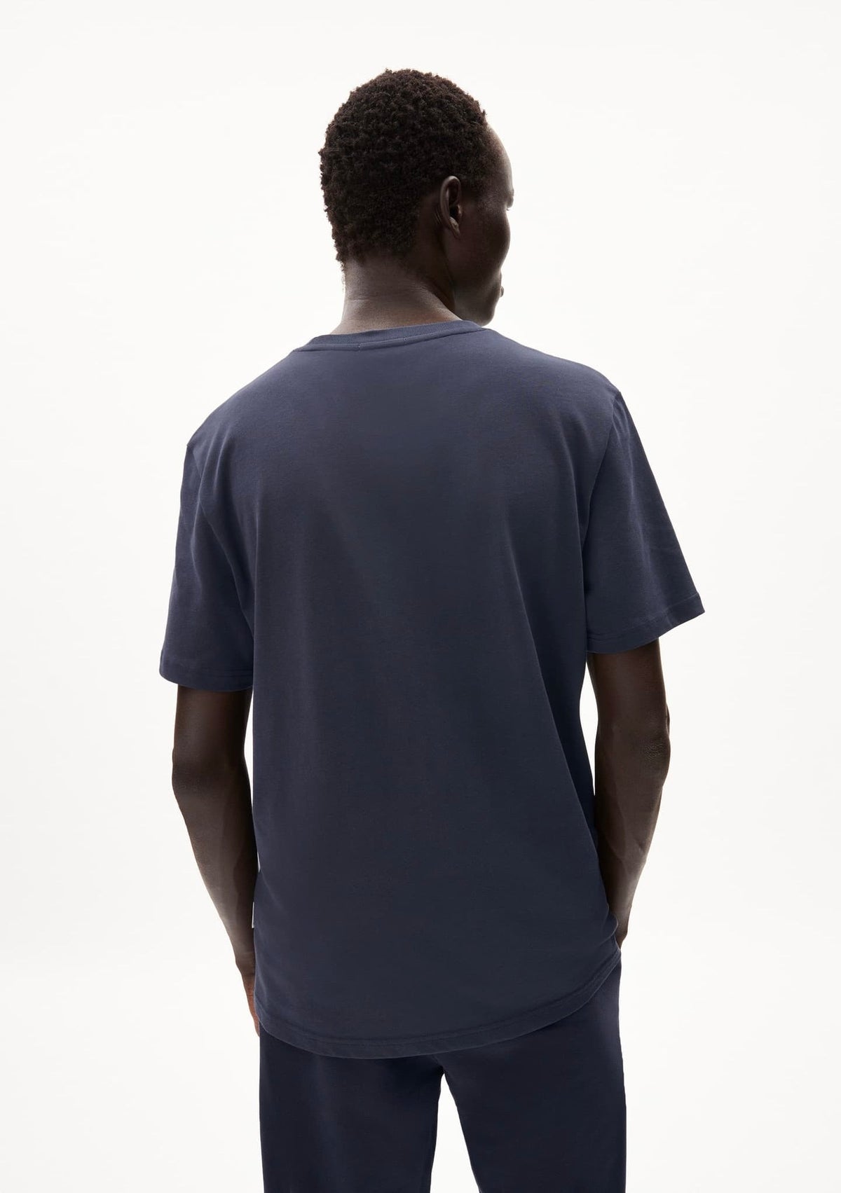 Back view of a man wearing the ARMEDANGELS Canada Maarkos Heavy Weight T-Shirt in night sky on a white background.