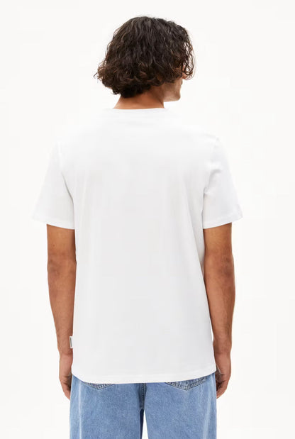 Back view of a man wearing the ARMEDANGELS Canada Maarkos Heavy Weight T-Shirt in white with light jeans on a white background.