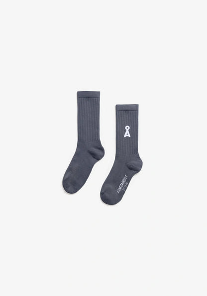 Two light navy socks with a logo on a light gray background