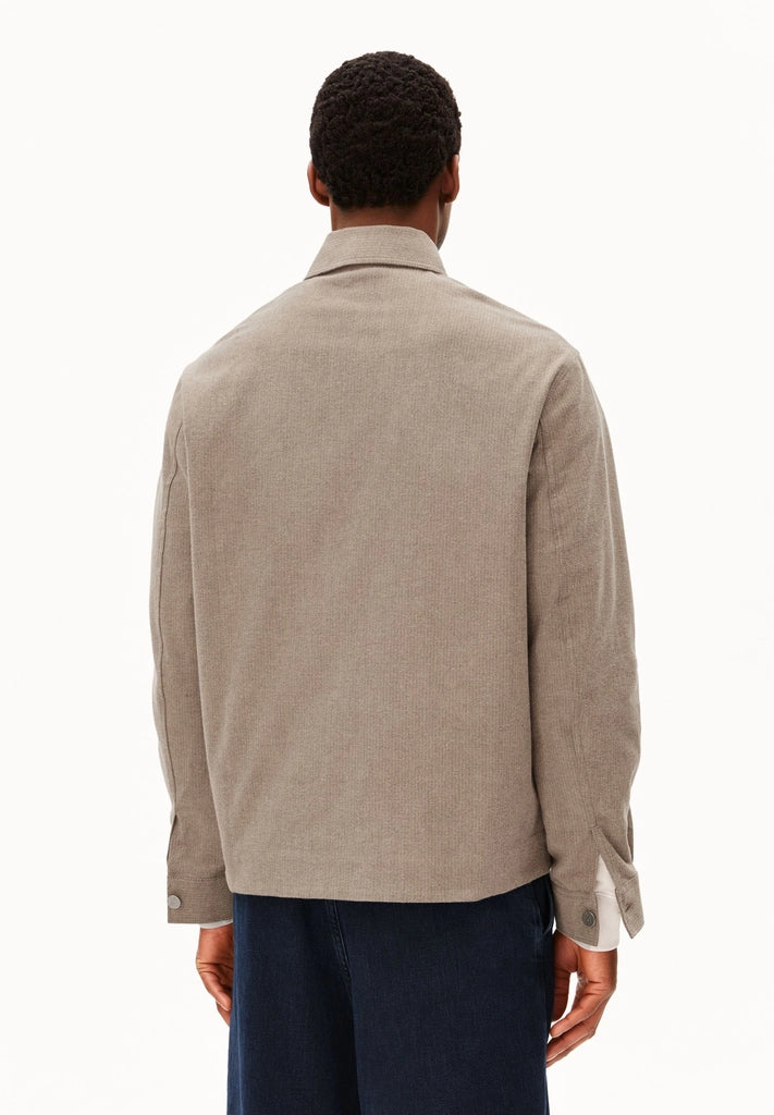 Back view of a man wearing ARMEDANGELS Canada Structured Jacket in Honey Reed, showing the relaxed fit, against a white background.