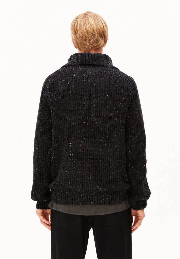 Back view of a man wearing the ARMEDANGELS Canada Tweed Knit Half-Zip Sweater in black on a white studio background.
