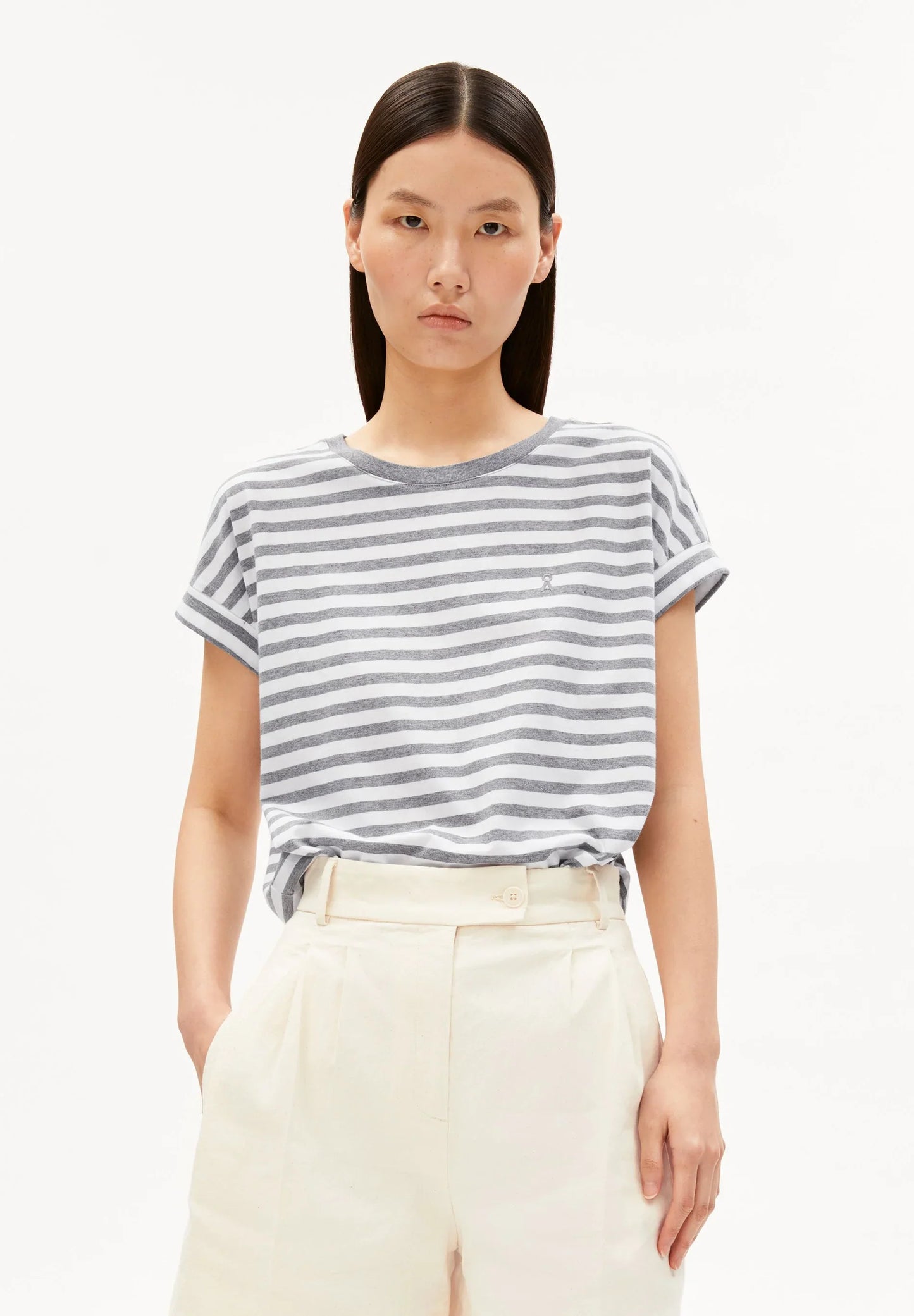 Woman wearing a striped t-shirt and white pants on a white background for Kelowna and Canada