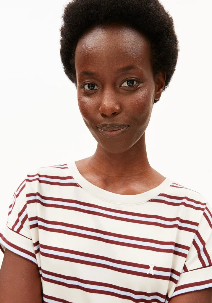 A close-up shot of a model wearing a short-sleeve crewneck t-shirt with horizontal burgundy and white stripes, set against a plain white background.