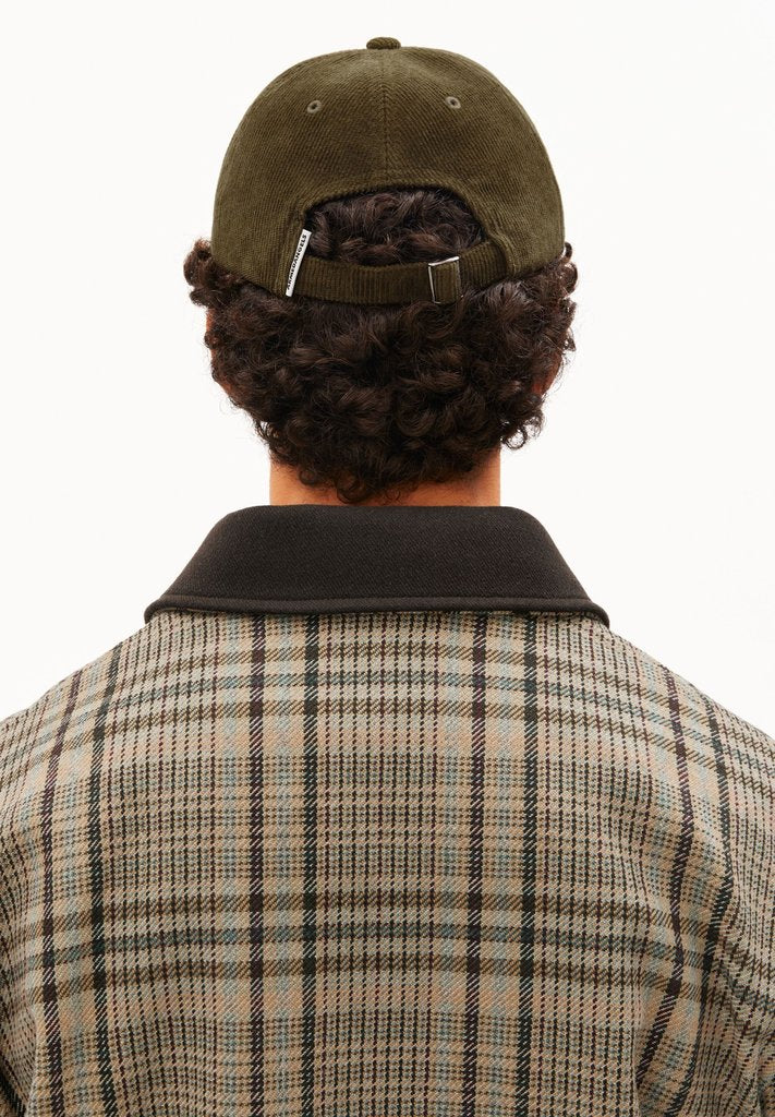 Back view of a man wearing ARMEDANGELS Canada Yenaas Cord Cap in Dark Earth, showing the back closure, against a white background.