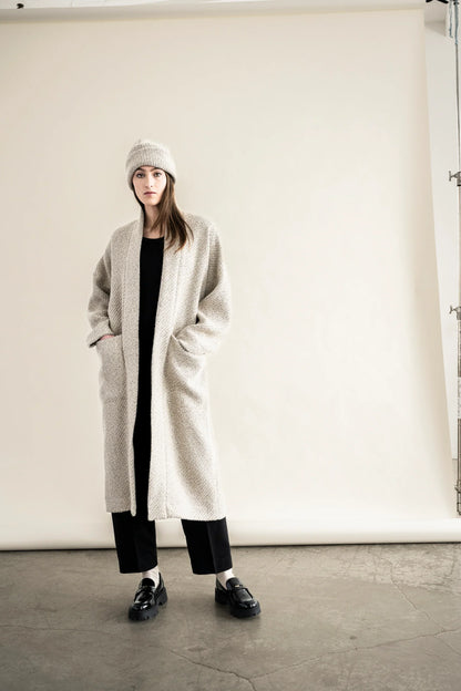 BodyBag by Jude long cream textured cardigan with pockets worn over black outfit and matching beanie in Kelowna