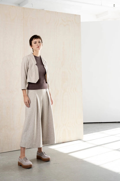 Three-quarter view of the Bodybag by Jude Nassau Jacket in Sand, showing the cropped length and the clean tailored line from shoulder to hem.