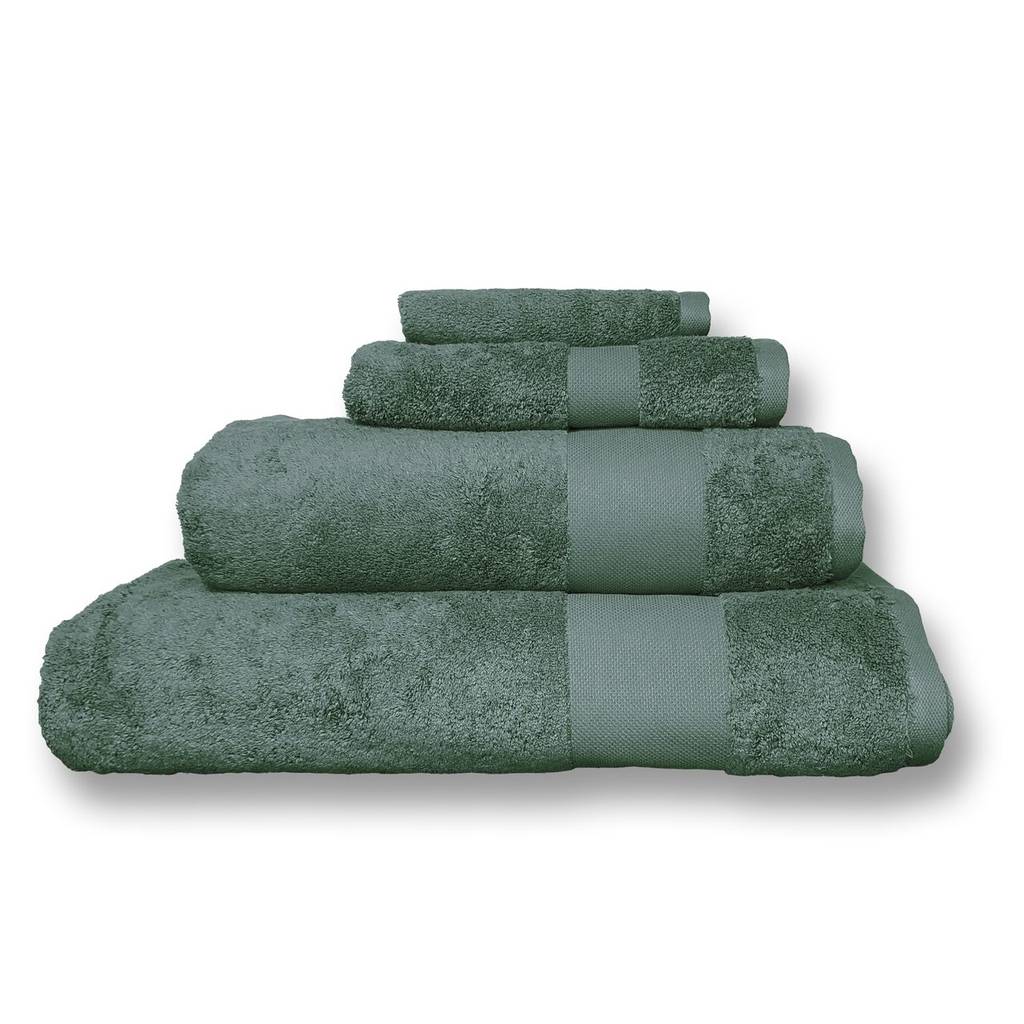 A set of four folded bath towels in a spruce green color, arranged in a stepped stack on a white background.