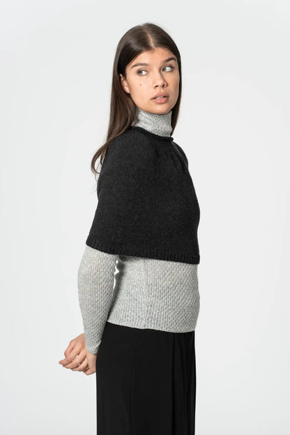 Dinadi black poncho styled over a grey sweater, perfect for layering and warmth in Kelowna and Canada